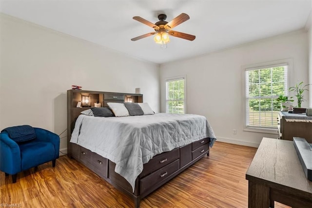 2515 E Woodlyn Way, Greensboro, NC 27407 - bedroom with multiple windows, wood finished floors, baseboards, ornamental molding, and a ceiling fan