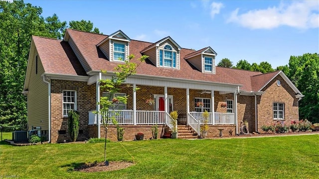 2515 E Woodlyn Way, Greensboro, NC 27407 - cape cod home with brick siding, a porch, cooling unit, a front yard, and roof with shingles