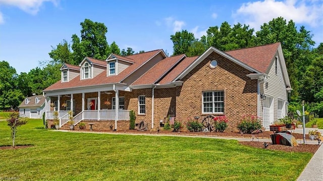 2515 E Woodlyn Way, Greensboro, NC 27407 - cape cod house with a porch, a front lawn, and brick siding