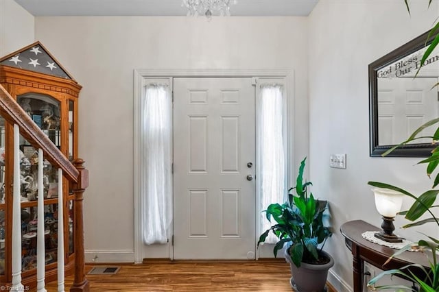 2515 E Woodlyn Way, Greensboro, NC 27407 - foyer featuring wood finished floors, baseboards, and stairway
