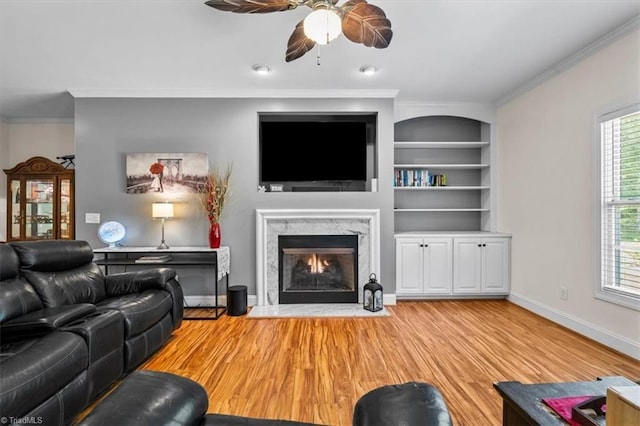 2515 E Woodlyn Way, Greensboro, NC 27407 - living area featuring ceiling fan, wood finished floors, ornamental molding, baseboards, and a premium fireplace