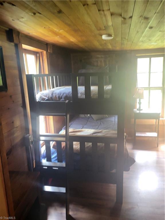 3273 N NC Highway 16, Millers Creek, NC 28651 - bedroom with wood ceiling, wood walls, and wood finished floors