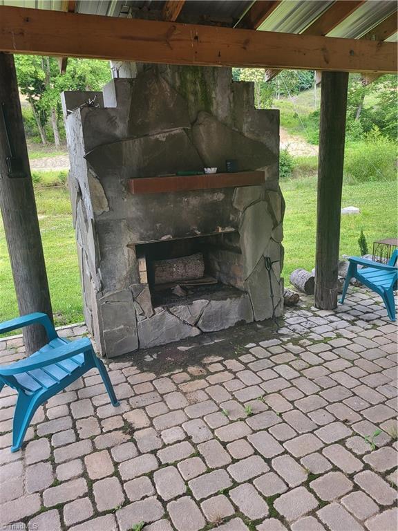3273 N NC Highway 16, Millers Creek, NC 28651 - view of patio with an outdoor stone fireplace