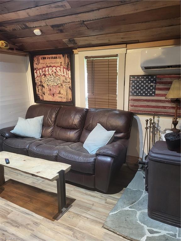3273 N NC Highway 16, Millers Creek, NC 28651 - living area with a wall mounted air conditioner, wooden ceiling, and wood finished floors