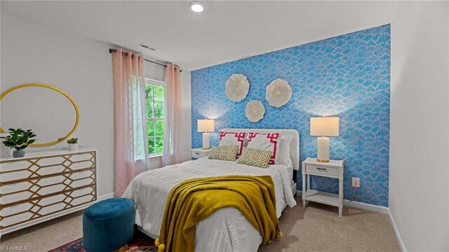144 Rose Wind Way, Mayodan, NC 27027 - carpeted bedroom with visible vents, wallpapered walls, an accent wall, and baseboards