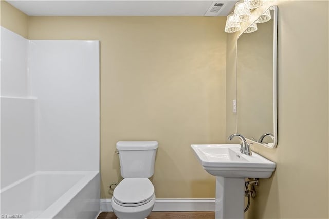 bathroom featuring a tub to relax in and toilet