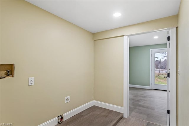 laundry area with electric dryer hookup, hookup for a washing machine, and light hardwood / wood-style floors