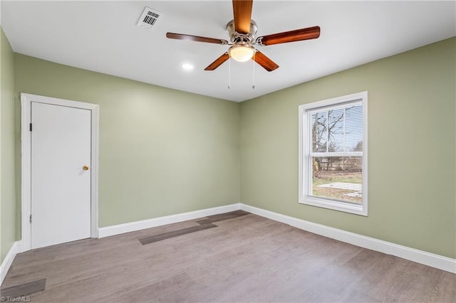 spare room with light hardwood / wood-style flooring and ceiling fan