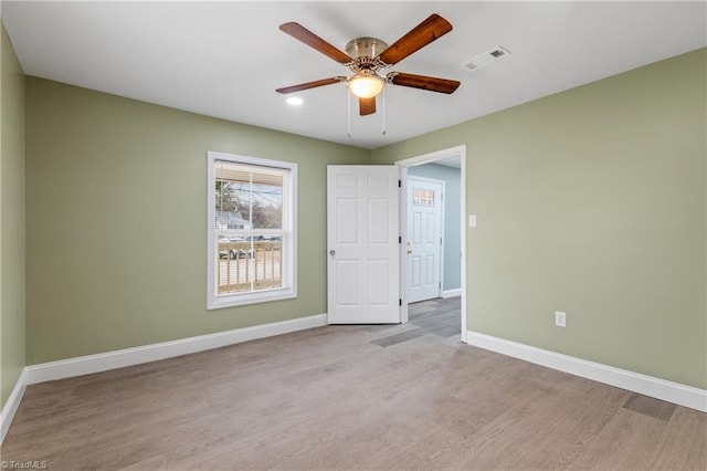 unfurnished room with ceiling fan and light hardwood / wood-style floors