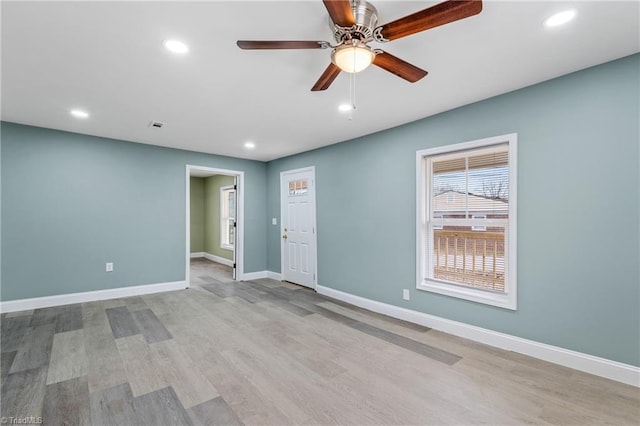 empty room with light wood-type flooring and ceiling fan