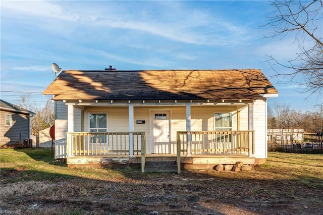 rear view of property with covered porch and central air condition unit