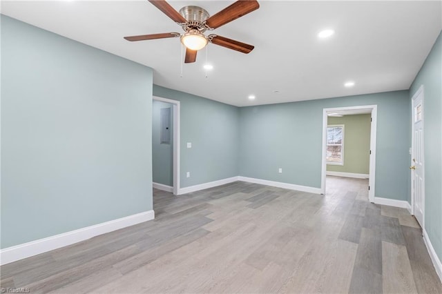 spare room with ceiling fan and light wood-type flooring