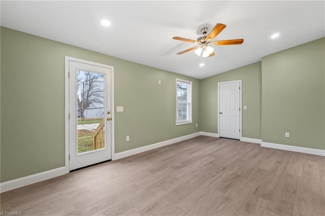 empty room with light hardwood / wood-style floors, ceiling fan, and lofted ceiling