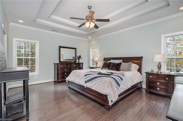 bedroom featuring dark hardwood / wood-style floors, a raised ceiling, ceiling fan, and crown molding