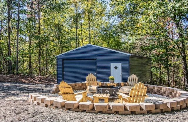 view of outbuilding with an outdoor fire pit