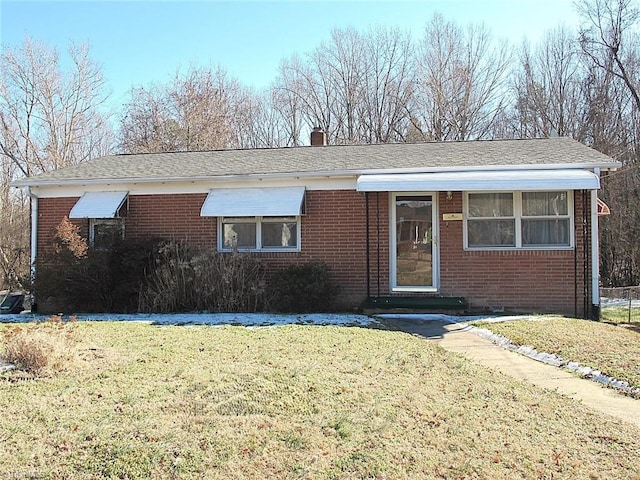 ranch-style house featuring a front lawn