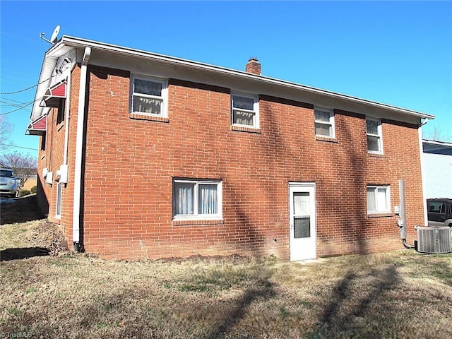 rear view of house featuring central AC unit