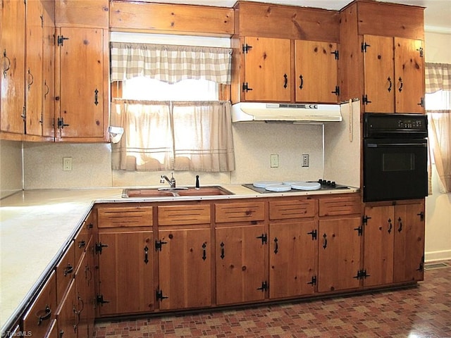 kitchen with black appliances, backsplash, and sink