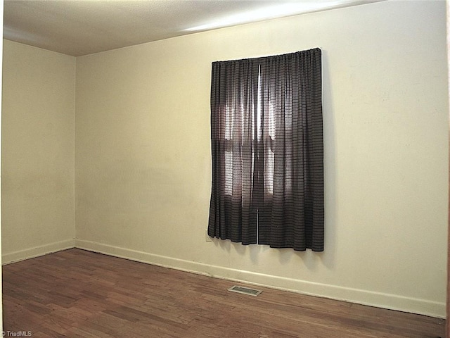 empty room featuring dark wood-type flooring