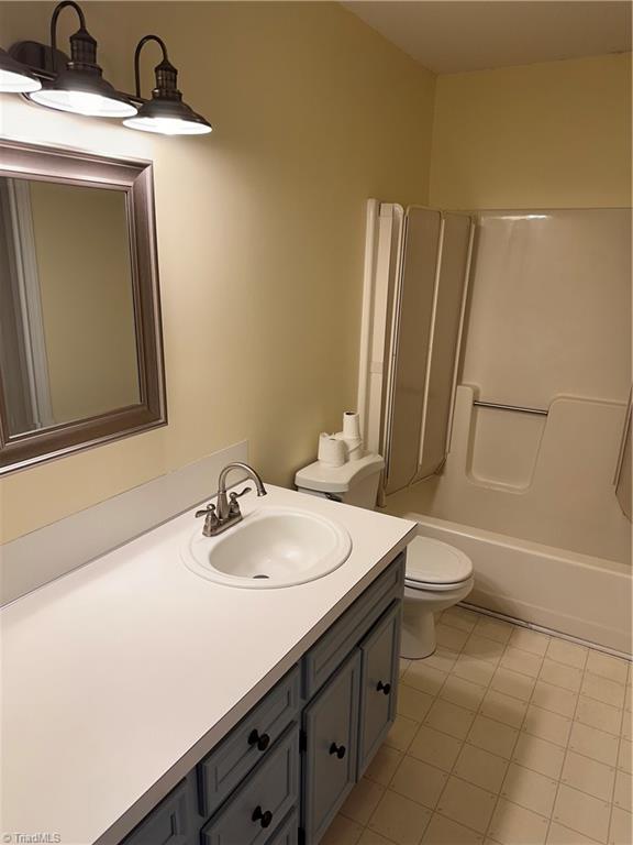 full bathroom with tile patterned flooring, vanity, toilet, and shower / bathtub combination