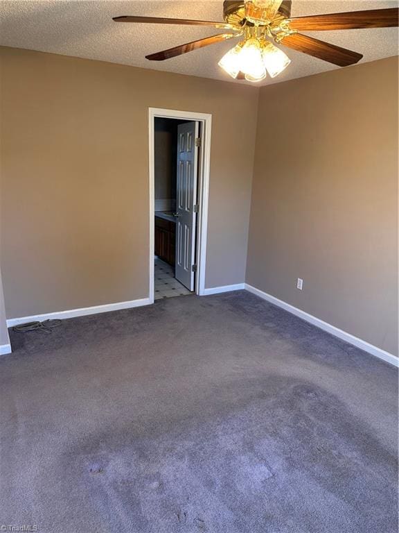 unfurnished room with ceiling fan, carpet floors, and a textured ceiling