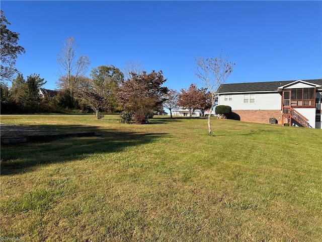 view of yard featuring a sunroom