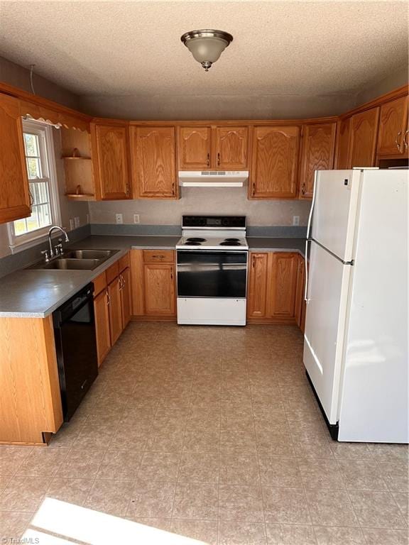 kitchen featuring a textured ceiling, sink, and white appliances