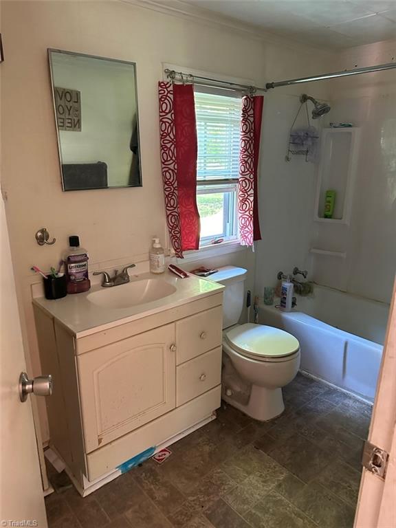 full bathroom featuring vanity, toilet, and washtub / shower combination