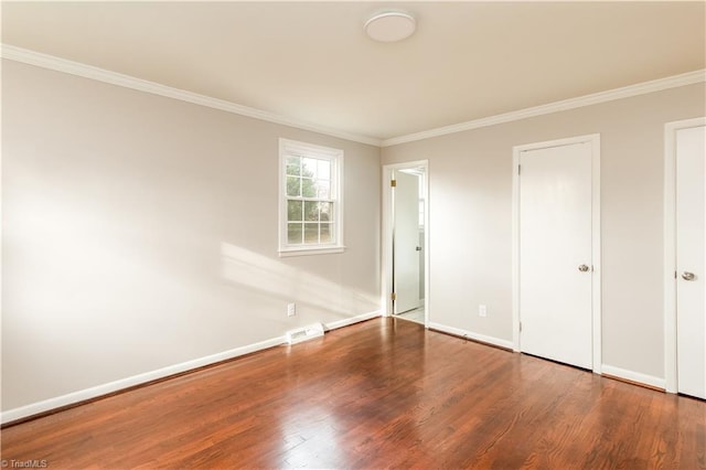 unfurnished bedroom featuring hardwood / wood-style floors and crown molding