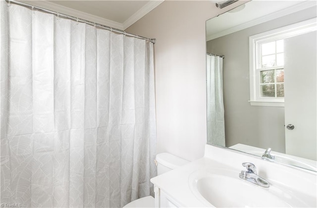 bathroom featuring crown molding, vanity, and toilet