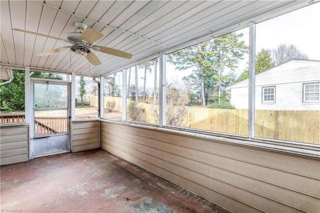 unfurnished sunroom with ceiling fan