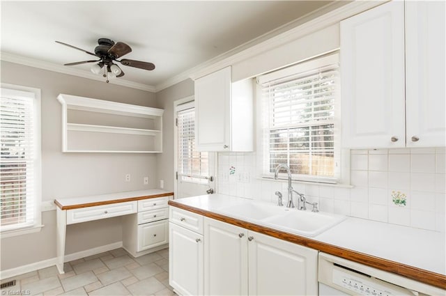 kitchen featuring white dishwasher, sink, decorative backsplash, ceiling fan, and white cabinetry