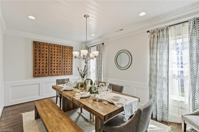 dining area with a healthy amount of sunlight, crown molding, and dark wood-type flooring