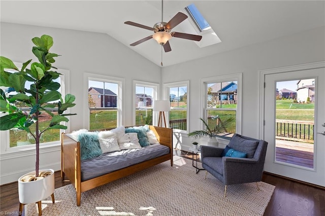 sunroom with ceiling fan and vaulted ceiling with skylight