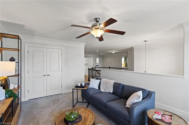 living room featuring carpet, ceiling fan, and crown molding