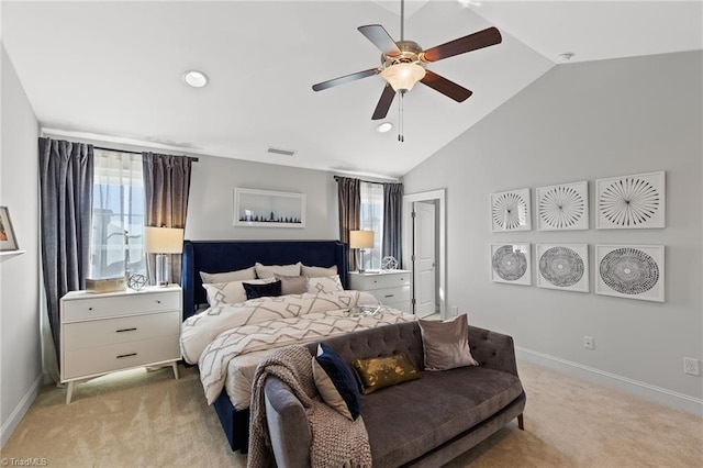 bedroom with light carpet, multiple windows, ceiling fan, and lofted ceiling