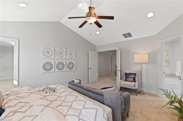 bedroom with light carpet, ensuite bathroom, a walk in closet, ceiling fan, and a closet