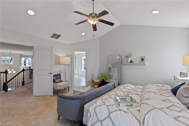 bedroom featuring ceiling fan with notable chandelier, light carpet, and vaulted ceiling