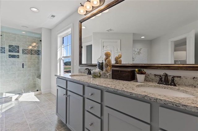 bathroom with tile patterned floors, vanity, and an enclosed shower