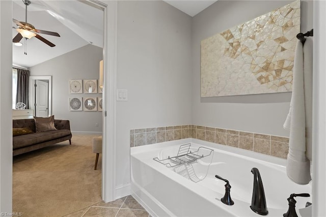 bathroom with tile patterned flooring, a tub, ceiling fan, and lofted ceiling