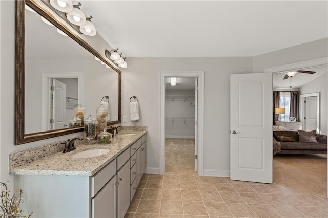 bathroom featuring tile patterned flooring, vanity, and ceiling fan