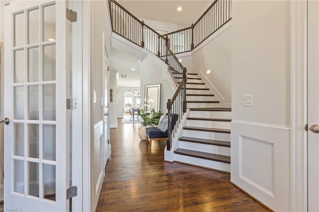 foyer with dark hardwood / wood-style floors and crown molding