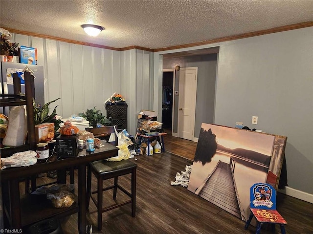 interior space with a textured ceiling, dark hardwood / wood-style flooring, and crown molding