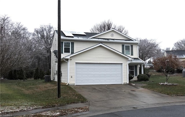 view of front property featuring solar panels, a garage, central air condition unit, and a front yard