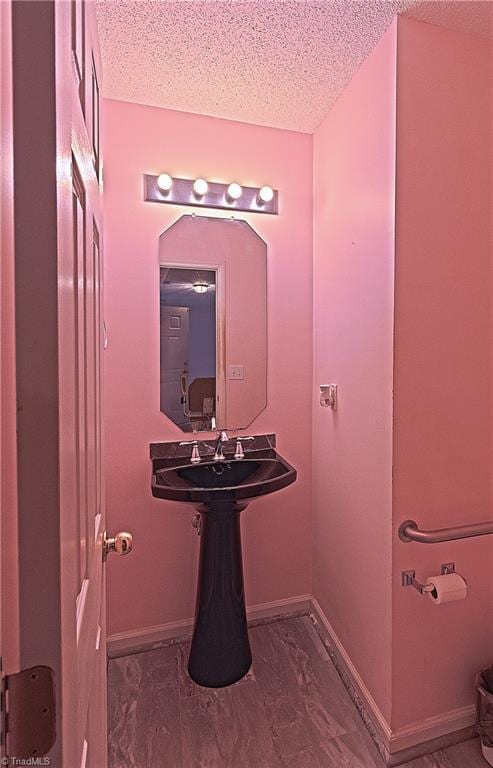 bathroom featuring sink and a textured ceiling