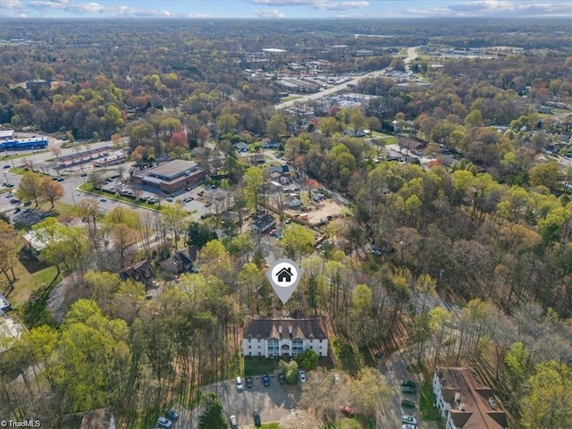 aerial view of property's location featuring a heavily wooded area