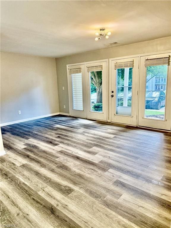 unfurnished room featuring wood finished floors and baseboards