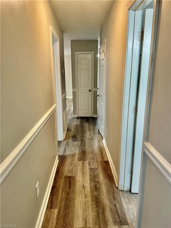 hall with wood finished floors and baseboards