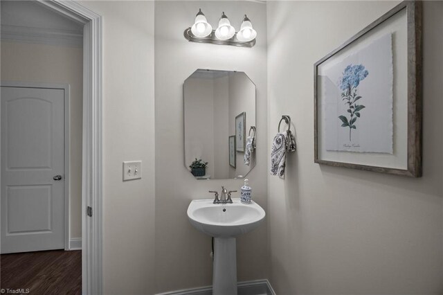 bathroom with wood finished floors and baseboards