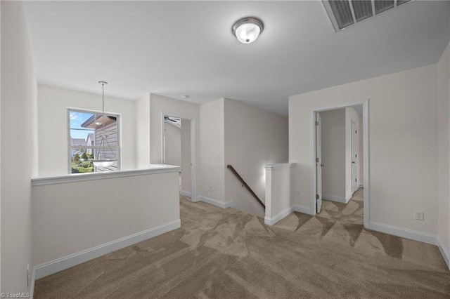 spare room featuring carpet floors and baseboards